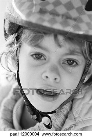Girl wearing helmet, crying, portrait, b&w View Large Photo Image Picture - Girl wearing helmet, crying, portrait, b&w. Fotosearch