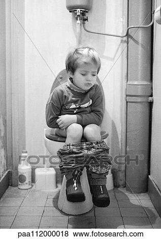 Stock Photo - Little girl sitting on toilet, b&w. Fotosearch