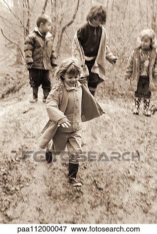 Three girls and boy in forest, b&w View Large Photo Image Stock Photo - Three girls and boy in forest, b&w. Fotosearch
