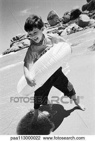 Child in inner tube at the beach, B&W View Large Photo Image Stock Image - Child in inner tube at the beach, B&W. Fotosearch