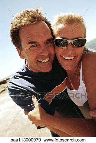 Close-up of man and woman hugging at the beach. View Large Photo Image Stock Photo - Close-up of man and woman hugging at the beach.. Fotosearch