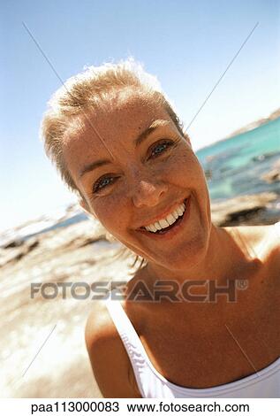 Close-up of woman at the beach. View Large Photo Image Stock Image - Close-up of woman at the beach.. Fotosearch