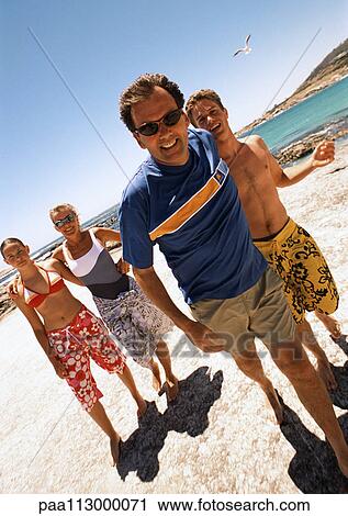 Family standing on the beach. View Large Photo Image Stock Image - Family standing on the beach.. Fotosearch