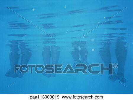 Four pairs feet and calves, underwater view View Large Photo Image Stock Photo - Four pairs feet and calves, underwater view. Fotosearch