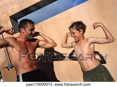 Man and boy flexing arm muscles, making faces. View Large Photo Image Stock Image - Man and boy flexing arm muscles, making faces.. Fotosearch