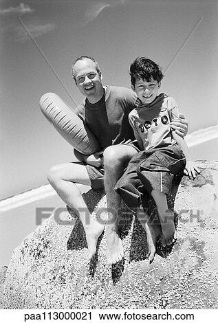 Man and child at the beach, B&W View Large Photo Image Stock Image - Man and child at the beach, B&W. Fotosearch