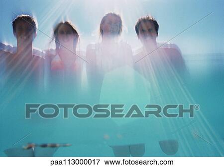 Two men and two women, low angle view, shot from underwater View Large Photo Image Stock Photo - Two men and two women, low angle view, shot from underwater. Fotosearch