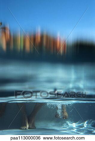 Two pairs of feet in water, underwater view View Large Photo Image Stock Photograph - Two pairs of feet in water, underwater view. Fotosearch