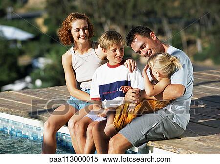 Young family, dressed, sitting on edge of pool. View Large Photo Image Stock Photography - Young family, dressed, sitting on edge of pool. . Fotosearch