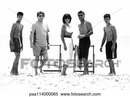 Adults standing on beach, b&w View Large Photo Image Stock Photography - Adults standing on beach, b&w. Fotosearch