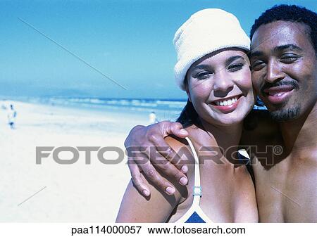 Couple on beach, close-up View Large Photo Image Stock Photo - Couple on beach, close-up. Fotosearch