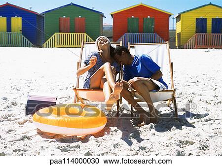 Couple sitting on beach on beach chairs View Large Photo Image Stock Image - Couple sitting on beach on beach chairs. Fotosearch