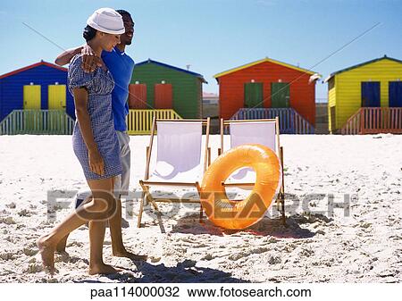 Stock Image - Couple walking on beach. Fotosearch
