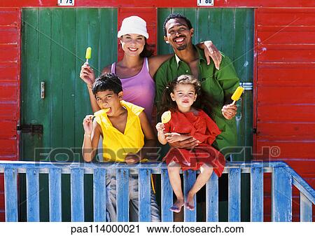 Stock Image - Family eating ice cream, parents smiling. Fotosearch