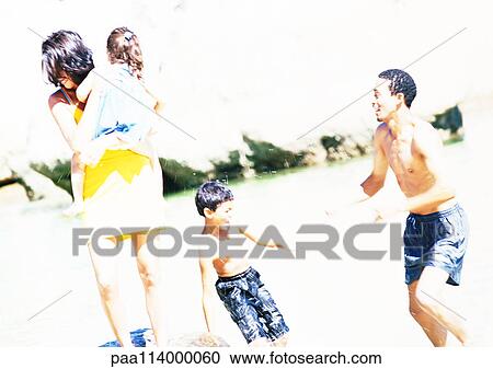 Stock Image - Family on beach. Fotosearch