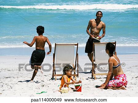 Stock Photo - Family on beach. Fotosearch