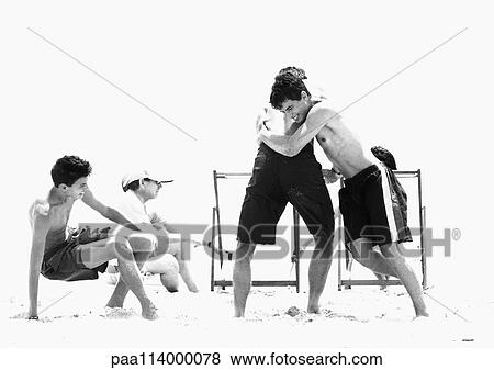 Stock Photo - Family playing on beach, b&w. Fotosearch