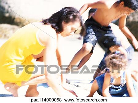 Family playing on beach, close-up View Large Photo Image Stock Photo - Family playing on beach, close-up. Fotosearch