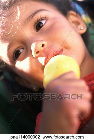 Girl eating ice cream, close-up View Large Photo Image Stock Image - Girl eating ice cream, close-up. Fotosearch