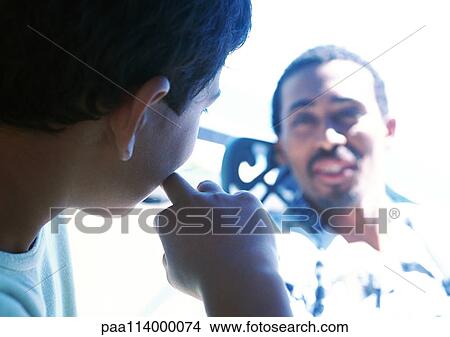 Man and boy talking, close-up View Large Photo Image Picture - Man and boy talking, close-up. Fotosearch
