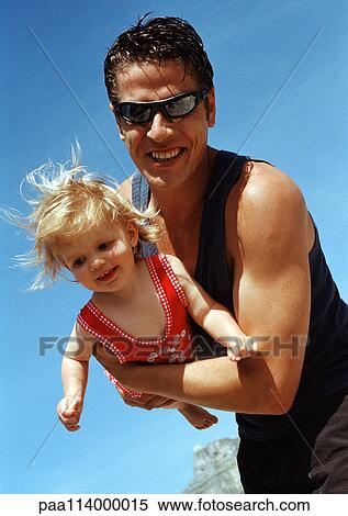 Stock Photography - Man holding little girl, close-up. Fotosearch