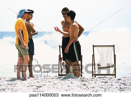 People standing on beach View Large Photo Image Stock Image - People standing on beach. Fotosearch