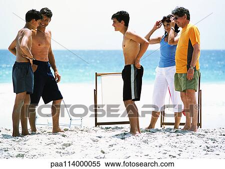 People standing on beach, talking View Large Photo Image Stock Photography - People standing on beach, talking. Fotosearch