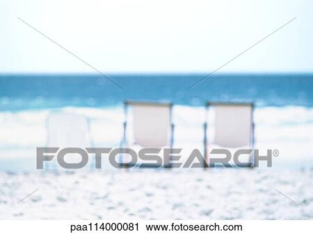Three deckchairs lined up on beach, sea in background, blurred View Large Photo Image Stock Image - Three deckchairs lined up on beach, sea in background, blurred. Fotosearch