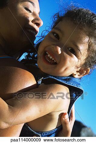 Stock Photo - Woman holding child, close-up. Fotosearch