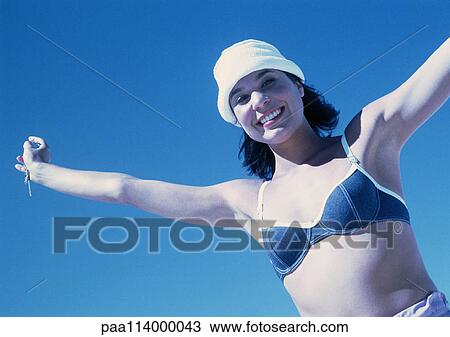 Woman in bathing suit standing with arms up View Large Photo Image Stock Image - Woman in bathing suit standing with arms up. Fotosearch
