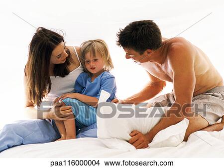 Picture - Couple and child on bed. Fotosearch