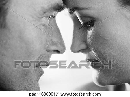 Stock Photo - Couple face to face, close-up, b&w. Fotosearch