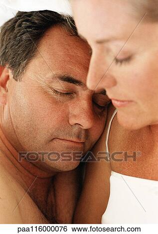 Couple sleeping side by side, eyes closed, close-up View Large Photo Image Stock Photograph - Couple sleeping side by side, eyes closed, close-up. Fotosearch