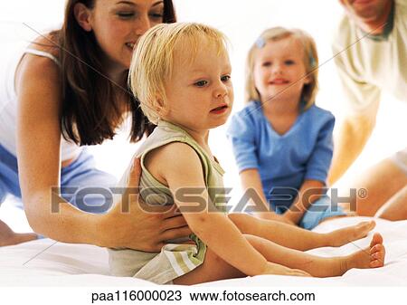 Stock Image - Family, woman holding little girl. Fotosearch