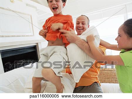 Father and children having pillow fight View Large Photo Image Stock Photography - Father and children having pillow fight. Fotosearch