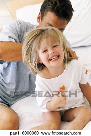 Father and daughter on bed, girl smiling View Large Photo Image Stock Image - Father and daughter on bed, girl smiling. Fotosearch