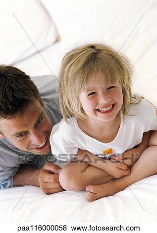 Father and daughter smiling, close-up View Large Photo Image Stock Photo - Father and daughter smiling, close-up. Fotosearch