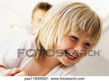 Girl smiling, close-up, man in background View Large Photo Image Stock Image - Girl smiling, close-up, man in background. Fotosearch