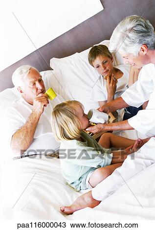 Grandparents and children on bed, drinking View Large Photo Image Stock Image - Grandparents and children on bed, drinking. Fotosearch