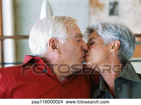 Mature couple kissing, side view View Large Photo Image Picture - Mature couple kissing, side view. Fotosearch
