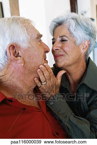 Mature woman caressing mature man's face View Large Photo Image Stock Photo - Mature woman caressing mature man's face. Fotosearch
