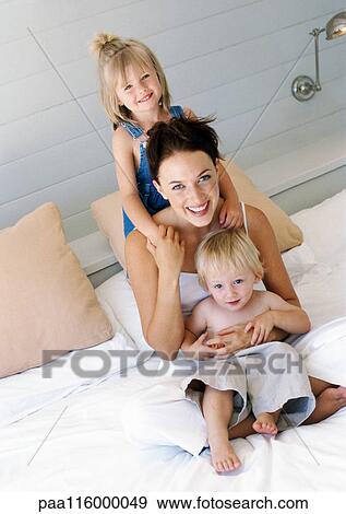 Mother and children on bed View Large Photo Image Stock Photo - Mother and children on bed. Fotosearch