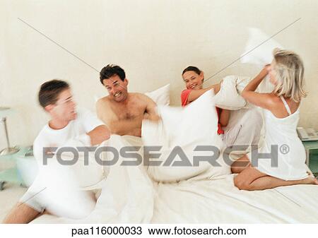 Parents and children having pillow fight, blurred motion View Large Photo Image Stock Image - Parents and children having pillow fight, blurred motion. Fotosearch