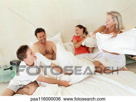 Parents and children having pillow fight, blurred motion View Large Photo Image Stock Photograph - Parents and children having pillow fight, blurred motion. Fotosearch