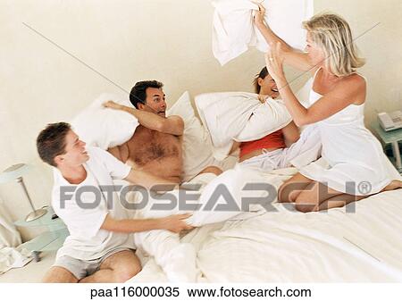Parents and children having pillow fight, blurred motion View Large Photo Image Stock Photography - Parents and children having pillow fight, blurred motion. Fotosearch