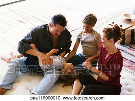 Parents and children playing on mattress View Large Photo Image Stock Image - Parents and children playing on mattress. Fotosearch