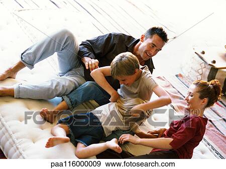 Parents and children playing on mattress View Large Photo Image Stock Photo - Parents and children playing on mattress. Fotosearch