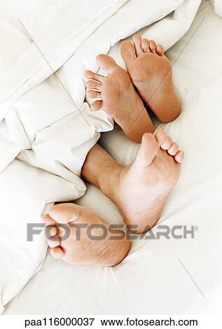 Two pairs of bare feet, close-up View Large Photo Image Stock Photo - Two pairs of bare feet, close-up. Fotosearch