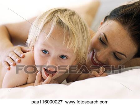 Woman and baby smiling, close-up View Large Photo Image Stock Photo - Woman and baby smiling, close-up. Fotosearch