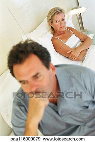 Woman in bed folding arms, man with hand on chin View Large Photo Image Stock Photo - Woman in bed folding arms, man with hand on chin. Fotosearch